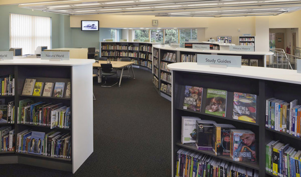 Curved shelving units displaying a variety of books in the study area at West Bridgford Library