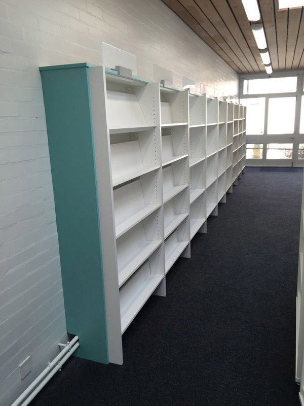 White browser shelving with a teal accent in a well-lit corridor at Albrighton Library