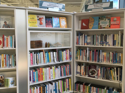 Colourful book displays featuring health and wellbeing titles in a dedicated browsing area at Conwy Culture Centre