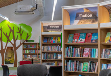 Library browsing layout design — curved face-out shelving and book merchandising zone