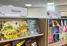 Children's library interior design — family library space with picture book displays and play elements