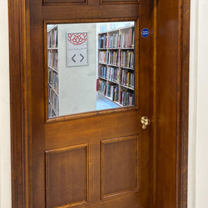 Custom shelving seen through newly restored door