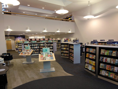 Curved book displays and browsing shelves in a public library browsing area at Thame Library
