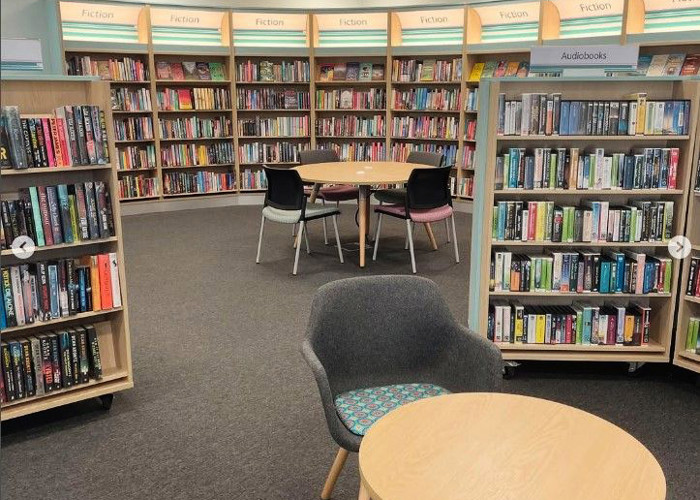 Library browsing layout design — curved face-out shelving and book merchandising zone