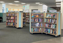 Small library interior design — compact community library space planning with warm wood ceiling