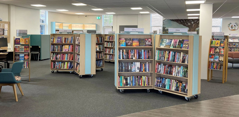 Mobile browsing shelves filled with books in a public library browsing area at Blaydon Library