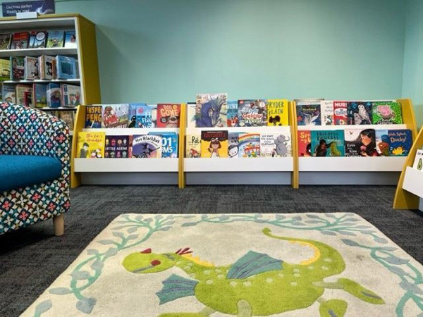Colourful face-out book displays featuring children's titles in a young readers' browsing space at Abergele Library