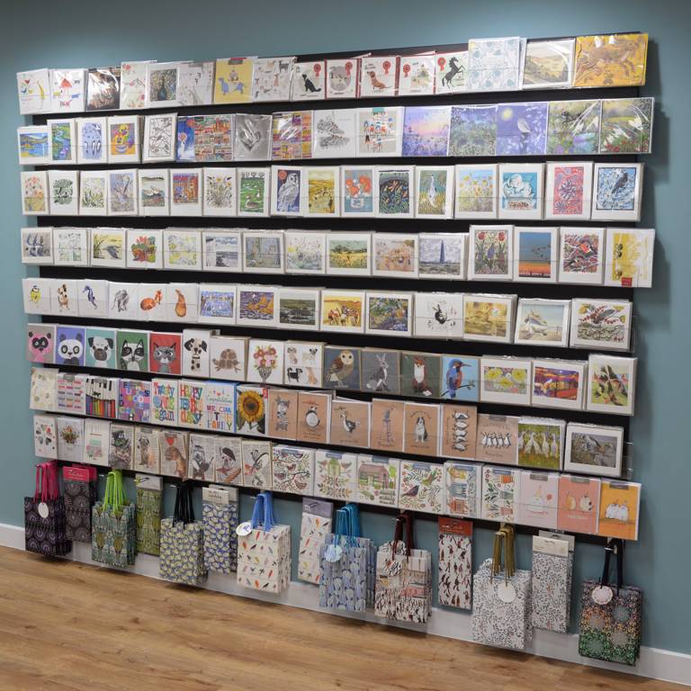 Wall-mounted display unit for cards and gift wrap in the library shop