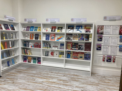 Brightly lit resource displays featuring business journals and information pamphlets at BIPC Leeds