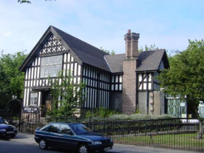 Tudor-style architecture with black and white timber framing and a prominent chimney at Sefton Park Library