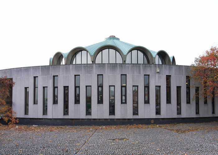 Heritage library interior design — vaulted stone arches and modern shelving in a historic library refurbishment