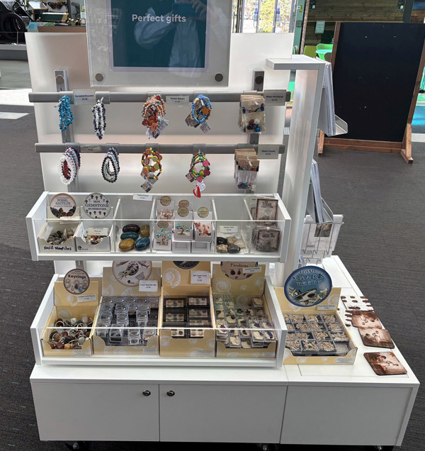 Display unit featuring a variety of jewellery and gift items at Oldham Library & Gallery Shop – perfect gifts