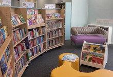 Children's library interior design — family library space with picture book displays and play elements