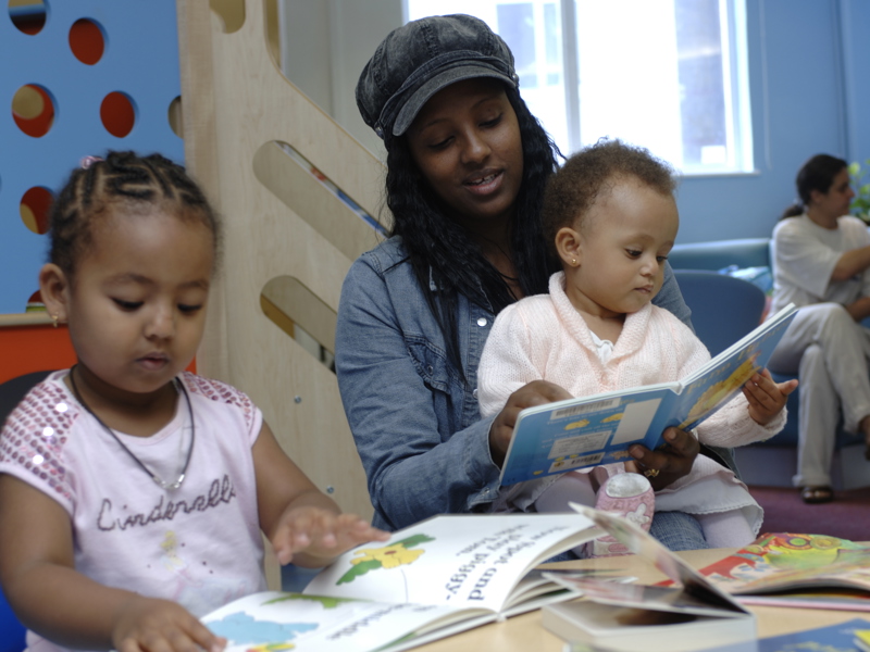 Children's library interior design — family library space with picture book displays and play elements