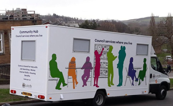 Silhouetted figures in various poses on a mobile community hub vehicle, promoting council services at Leeds Mobile Community Hub