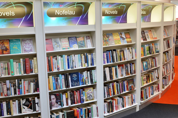 Colourful book displays featuring novels and a range of titles in a browsing area at Llandudno Library