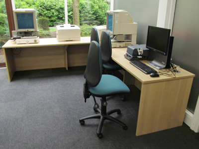 Two ergonomic chairs and computer workstations in a study area at Newark Local Studies