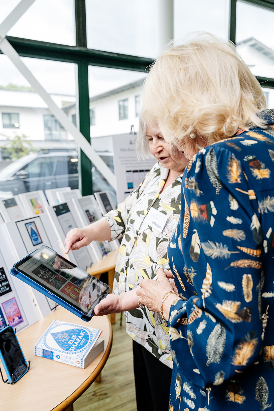 Her Majesty tries a book cover interactive from the Toolkit.