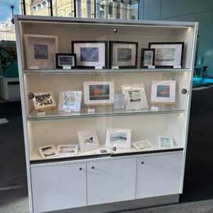 Tall fixed glazed cabinets at the edge of the space where they do not need to be moved