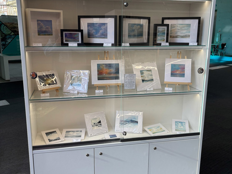 Tall fixed glazed cabinets at the edge of the space where they do not need to be moved