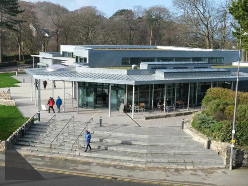 Modern architectural design with large glass windows and a spacious terrace at Conwy Culture Centre