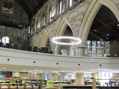 Exposed wooden beams and arched stone walls complement modern shelving and seating at Lichfield Library