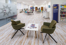 Library workspace design — co-working seating area in a public library business support zone