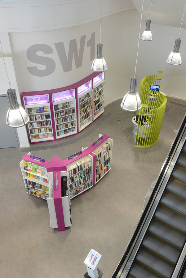 Brightly coloured face-out book displays and a circular browsing area with green shelving at Southwater Customer Services