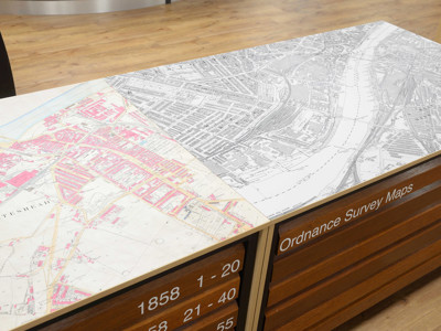 Detailed Ordnance Survey maps on a wooden counter surface in the local studies area at Gateshead Archive