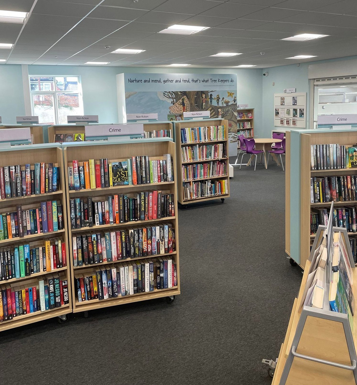 Colourful browser shelving filled with books in a public library browsing area at Birtley Library