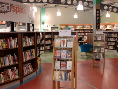 Face-out book displays and browsing shelves in a public library browsing area at High Street Library Bolton