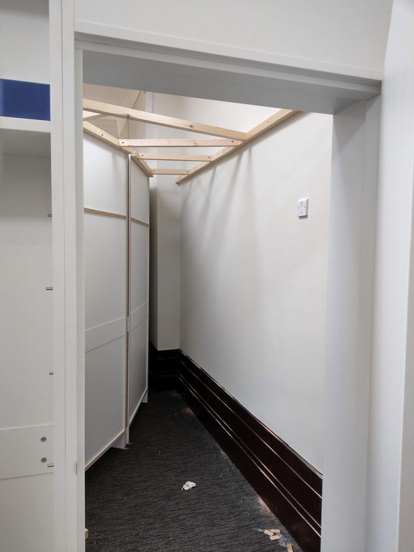 Custom shelving installation with scribed details around structural elements at Hunslet Library