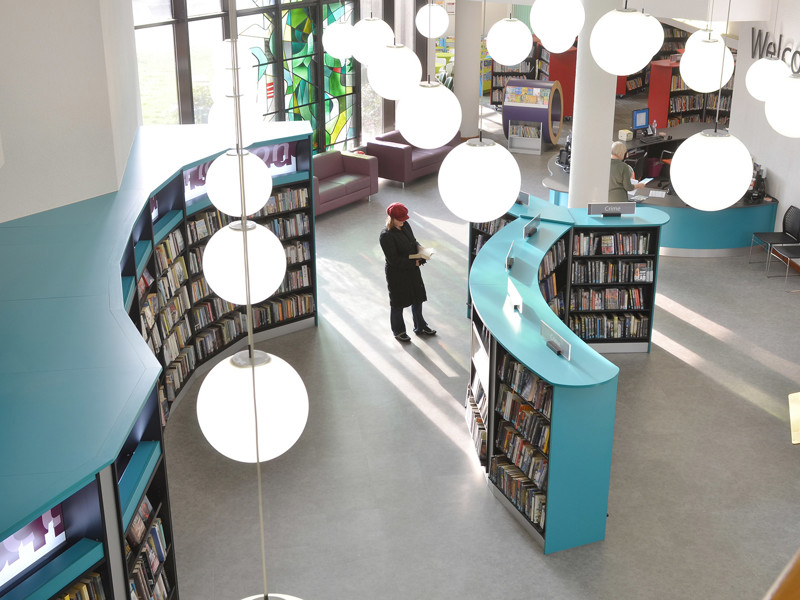 Large public library interior design — open plan shelving and reading areas in a central library refurbishment