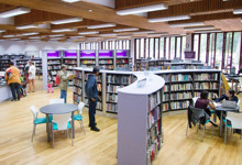 Large public library interior design — open plan shelving and reading areas in a central library refurbishment