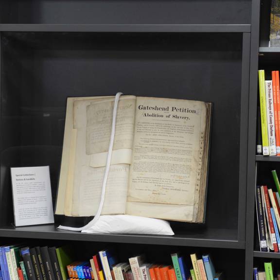One of our unique museum boxes fixed into a standard bookcase, displaying Gateshead Petition for the Abolition of Slavery