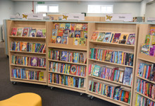 Children's library interior design — family library space with picture book displays and play elements