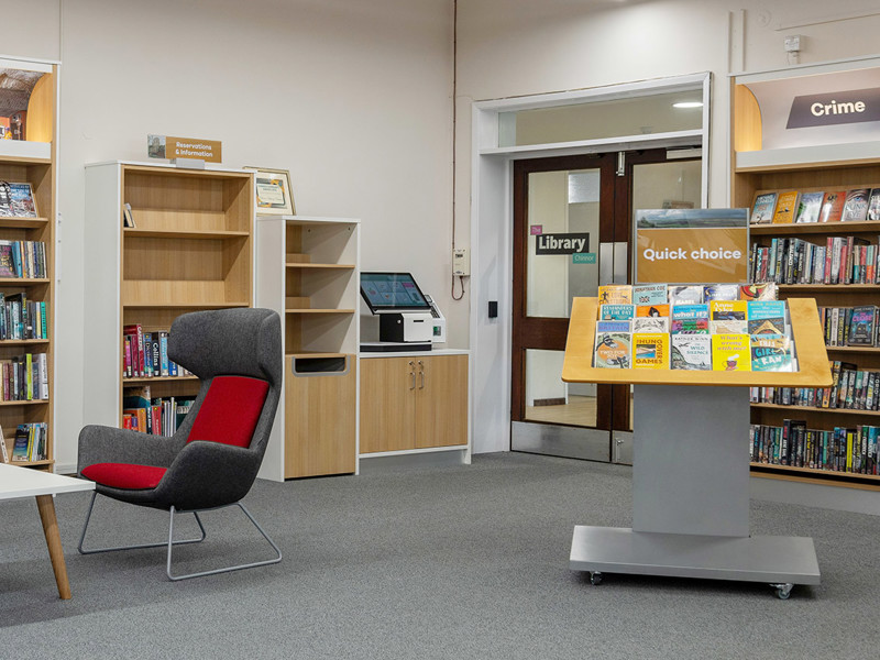 RFID self-service library design — kiosk housing with book return shelves integrated into library entrance