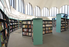 Heritage library interior design — vaulted stone arches and modern shelving in a historic library refurbishment