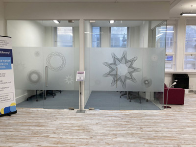 Frosted glass meeting rooms with geometric designs and modern chairs at BIPC Leeds