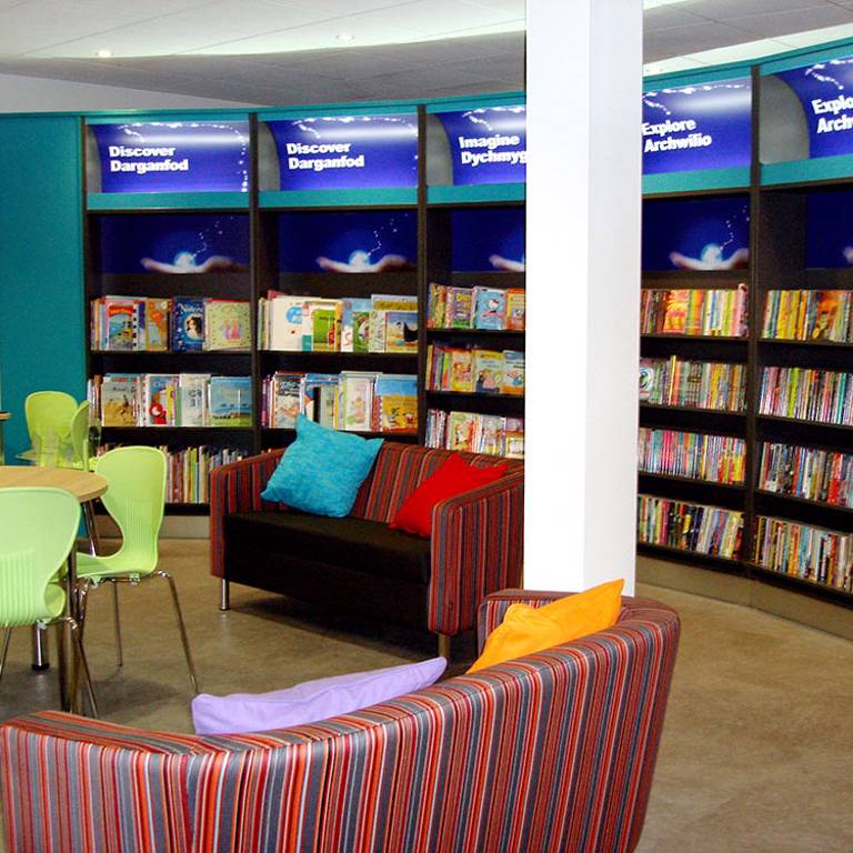 Colourful cushions on sofas in childrenâ€™s area, Bridgend Library