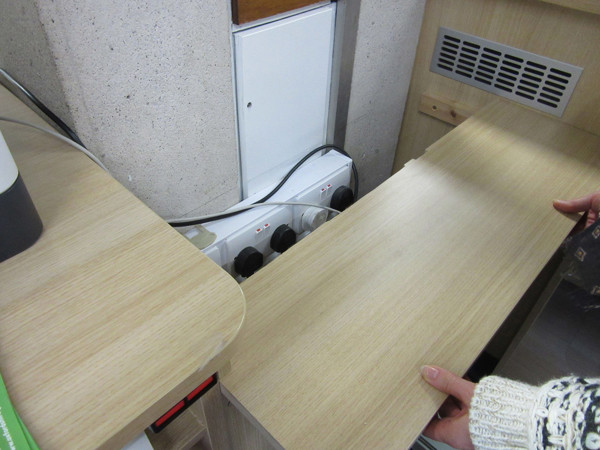 Custom shelving designed to fit around electrical outlets and conduits at County Library, Oxfordshire