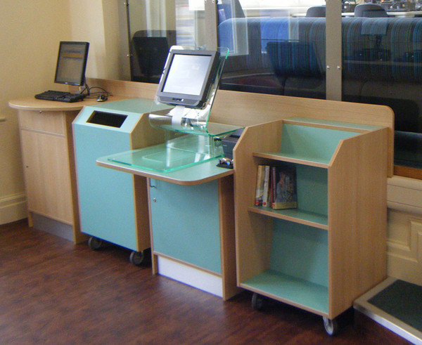 Self-service kiosk with a sleek design and integrated shelving for book returns at Failsworth Library