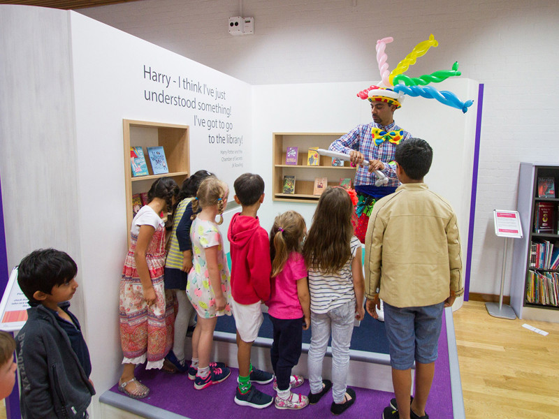 Children's library interior design — family library space with picture book displays and play elements