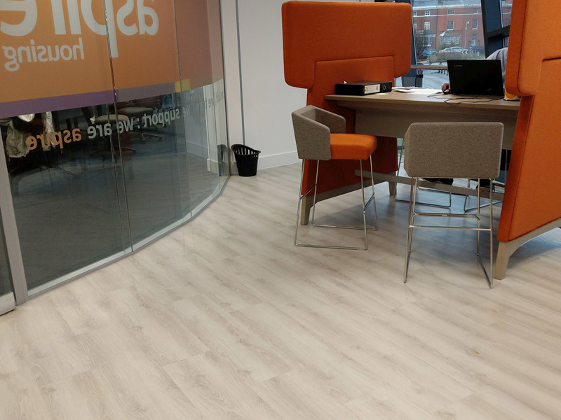 Orange high-backed seating and a collaborative work table in a modern workspace at Newcastle-under-Lyme Library