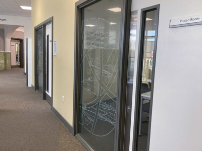 Frosted glass doors featuring intricate line art designs at the meeting room area at Danum Library