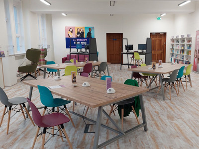 Colourful chairs around collaborative work tables in a shared workspace at BIPC Leeds