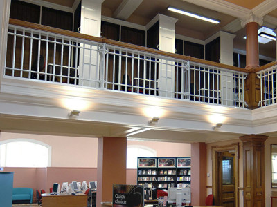 Curved skylight illuminating the open-plan library floor with a central display stand at Toxteth Library