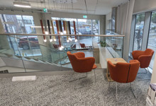 Library social space design — comfortable reading nook and seating area encouraging longer library visits
