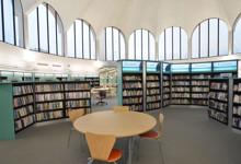 Heritage library interior design — vaulted stone arches and modern shelving in a historic library refurbishment