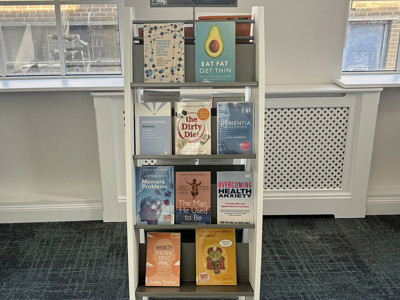 Wooden book display featuring health and wellbeing titles, including "Reading Well" and "Dementia" at Royton Library